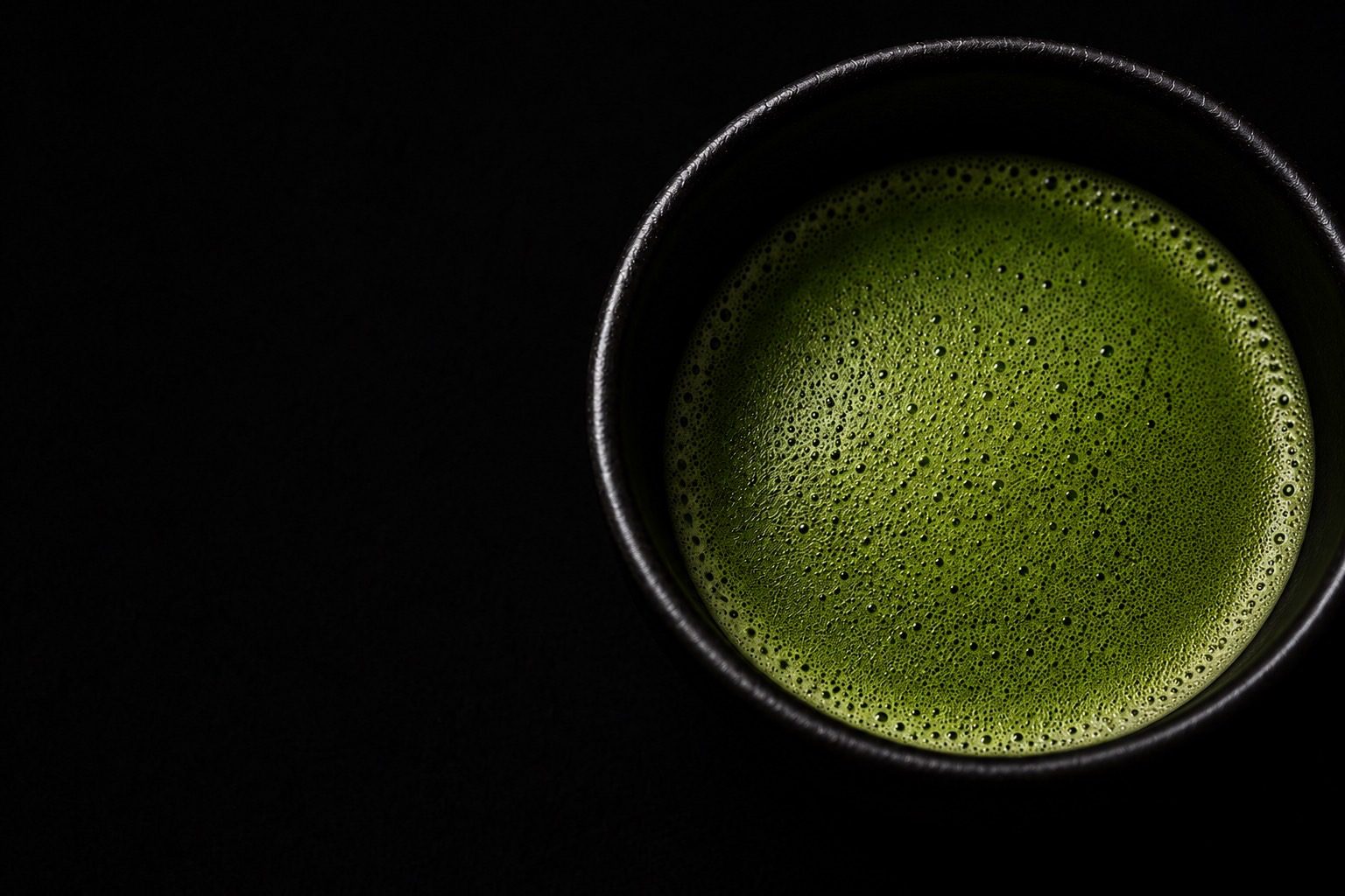 Matcha whisked in a black tea bowl